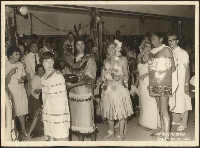 Costumed passengers participating in a fancy dress ball.