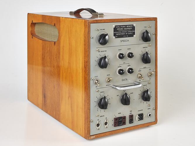 Silver control panel with knobs and dials, set in rectangular wooden box.