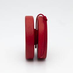 Red yo-yo with white cross.