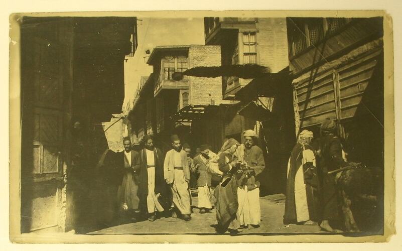 Iraqi people in narrow street in Baghdad.