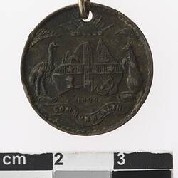 Round medal with Australian coat of arms.