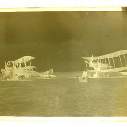 Three military aeroplanes landed in a desert field.