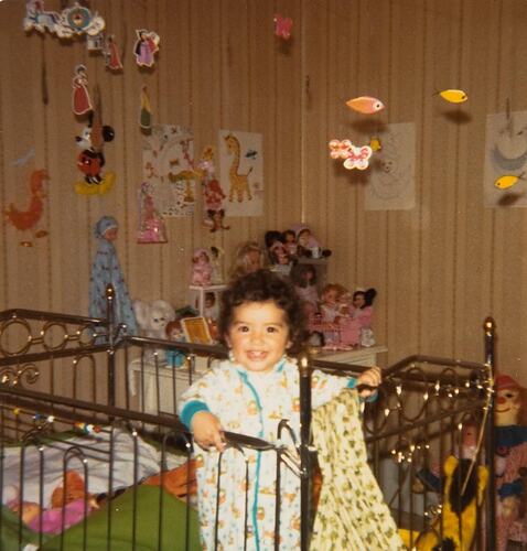 Digital Photograph - Baby in Romper Suit Standing in Cot, Bedroom, Footscray, 1978