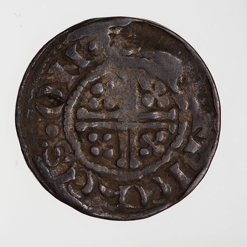 Coin, round, short cross voided within beaded circle, a quatrefoil in each angle; text around.