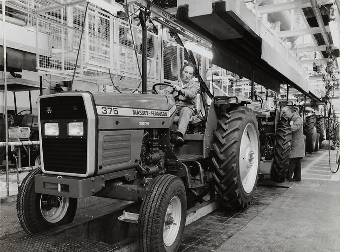 Photograph - Massey Ferguson, Worker Driving Tractor MF375 off Production Line, Banner Lane, Coventry, England, Nov 1986