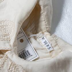 Collar of child's cream silk dress, registration number.