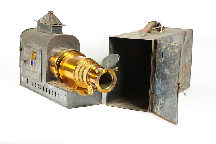 Metal box housing metal projector. Front of projector has brass telescopic cylinder.