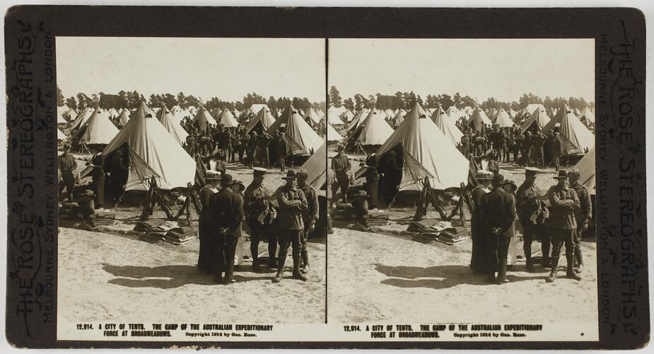 Soldiers and civilians in front of bell tents.