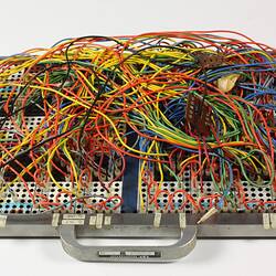 Jumble of coloured wires plugged into a board.
