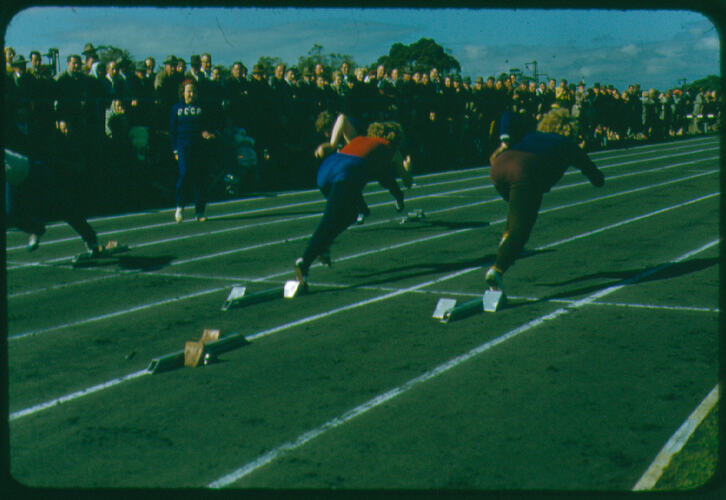 Female runners practising on an athletics track