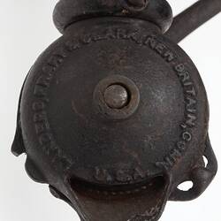 Detail of winder on metal and wood coffee grinder.