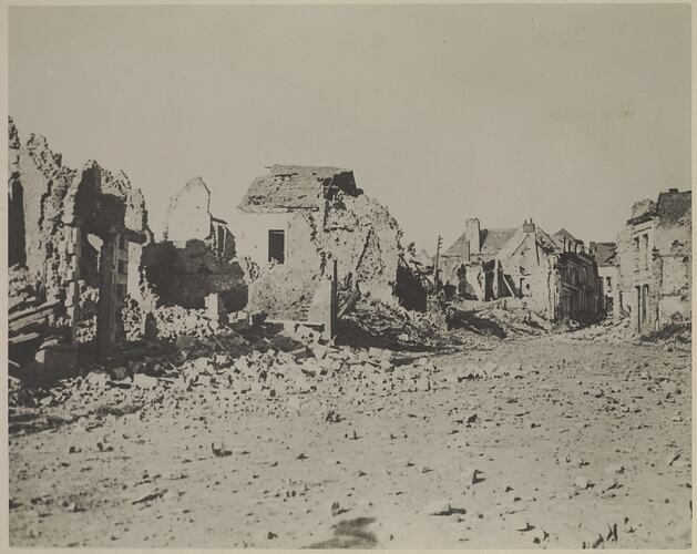 Streetscape showing destroyed buildings and rubble.