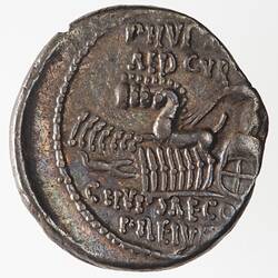 Round coin, aged, figure in chariot, with horses, scorpion nearby, writing above and below.