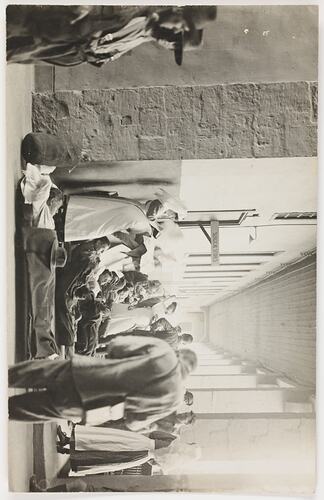 Crowd of nurses and patients, some on medical stretchers, outside building.