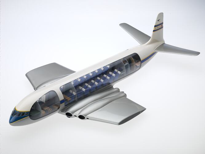 Model aeroplane with clear side panels showing internal cockpit and seating.