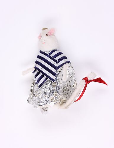 White toy mouse with striped blue shawl.