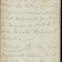 Open diary with handwritten text on discoloured worn page.