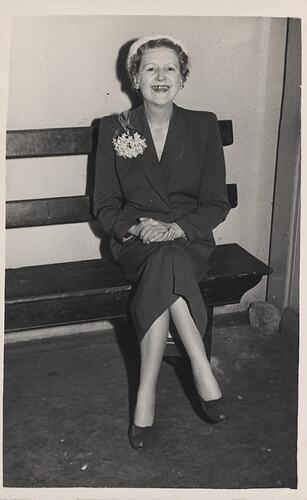 Woman seated on bench.