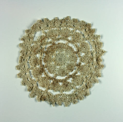 One side of stained cream doily.