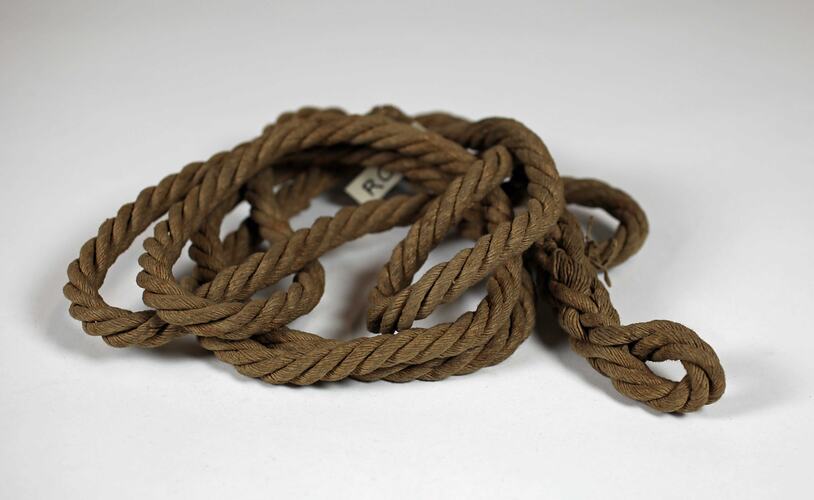 Coil of brown rope made of woven paper.