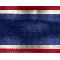 Patch of fabric with red, white and blue stripes.