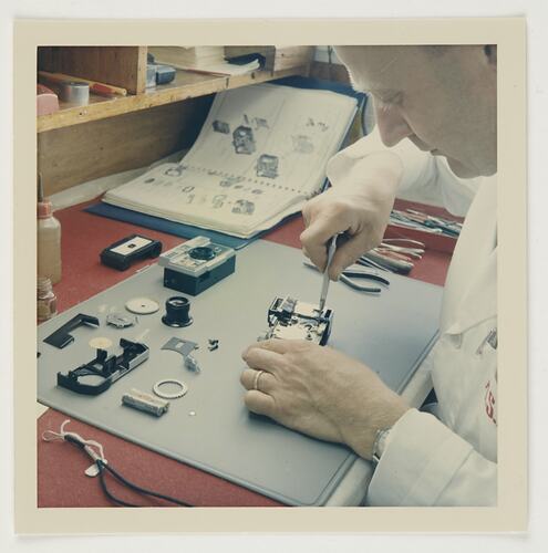 Slide 217, 'Extra Prints of Coburg Lecture', Worker With Disassembled Camera, Kodak Factory, Coburg, circa 1960s