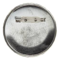 Back of round metal pin badge.