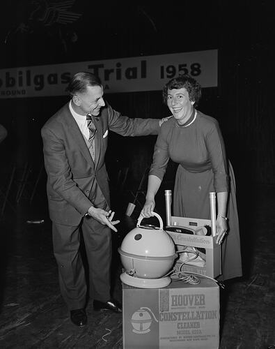 Man and Woman with Hoover, Mobilgas Trial, Olympic Stadium, Melbourne, Victoria, Sep 1958