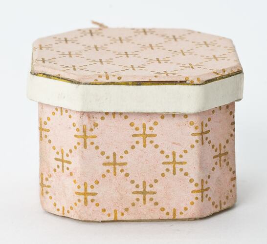 Doll's House pink angular hat box with gold pattern.