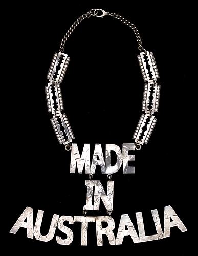 Metal necklace, 'MADE IN AUSTRALIA' hangs from 3 rectangular diamante plates on each side.