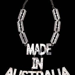 Metal necklace, 'MADE IN AUSTRALIA' hangs from 3 rectangular diamante plates on each side.