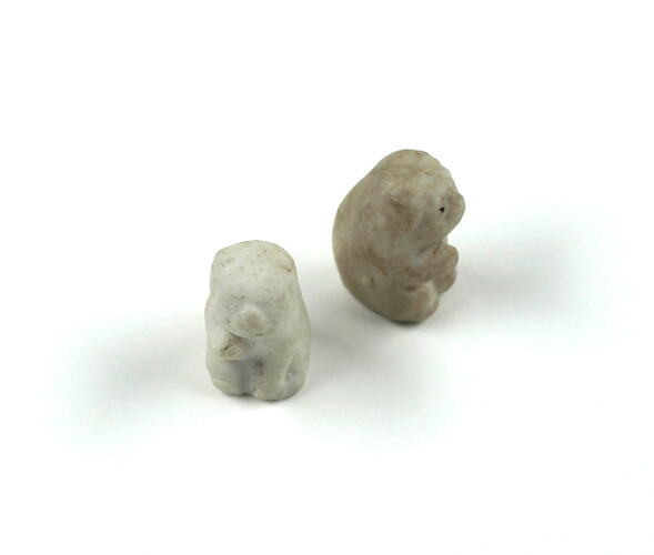 Two white animal figurines.