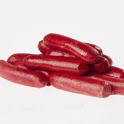 Pile of red sausages, miniature model.