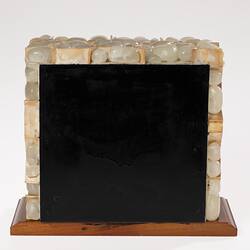 Rectangular shaped model of smooth white cells forming a wall. Wooden base, black back plate.