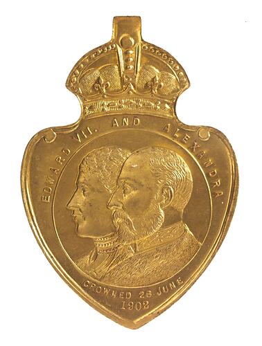 Shield shaped medal with crown above profile bust of man and woman.