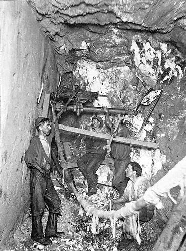 [Repairing a rock borer 1780 feet beneath the surface in the Great Northern Gold Mine, Bendigo, about 1905.]
