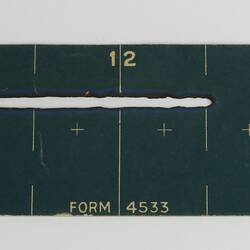 Long slim blue coloured card with white inscription.