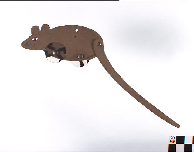Two dimensional brown cardboard mouse with legs painted on clear discs.