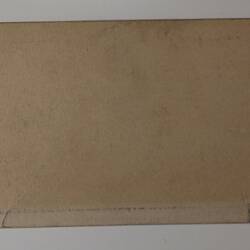 Back of off-white rectangular label.