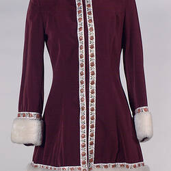 Long sleeved burgundy velvet mini jacket with braid and cream sheepskin cuffs and trim.