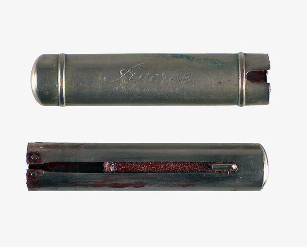 Lipstick with metal cover beside.