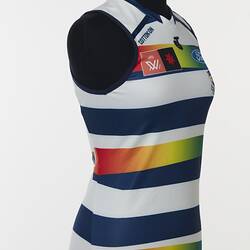 Women's AFLW guernsey with horizontal navy, white and rainbow stripes. Three quarter right front view.