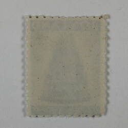 Rear of rectangular stamp with scalloped edge, blank.