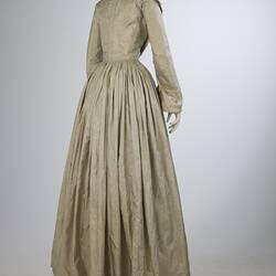 Pale grey striped silk dress with long sleeves and long skirt. Back view.