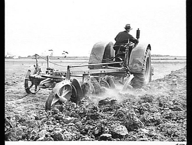 A 3-FURROW `SUNNIE' OVERBEAM NO. 2 DISC PLOUGH IN HARD SUNBAKED CLAY SOIL AT ALBION, VICTORIA, APRIL 1953.