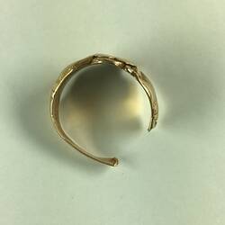 Back view of broken women's gold ring.