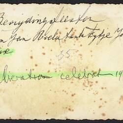 Discoloured white back of photograph with handwriting.
