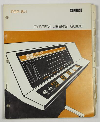White front cover with black and light brown printing and image of computer.