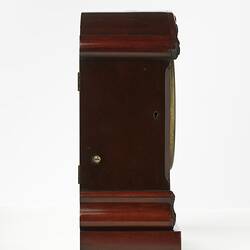 Mantel clock, mahogany case. Right profile.