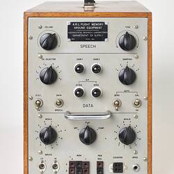 Silver control panel with knobs and dials, set in rectangular wooden box.